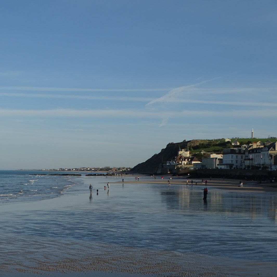 La plage à Arromanche-les-Bains avec la ville et une falaise en arrière plan